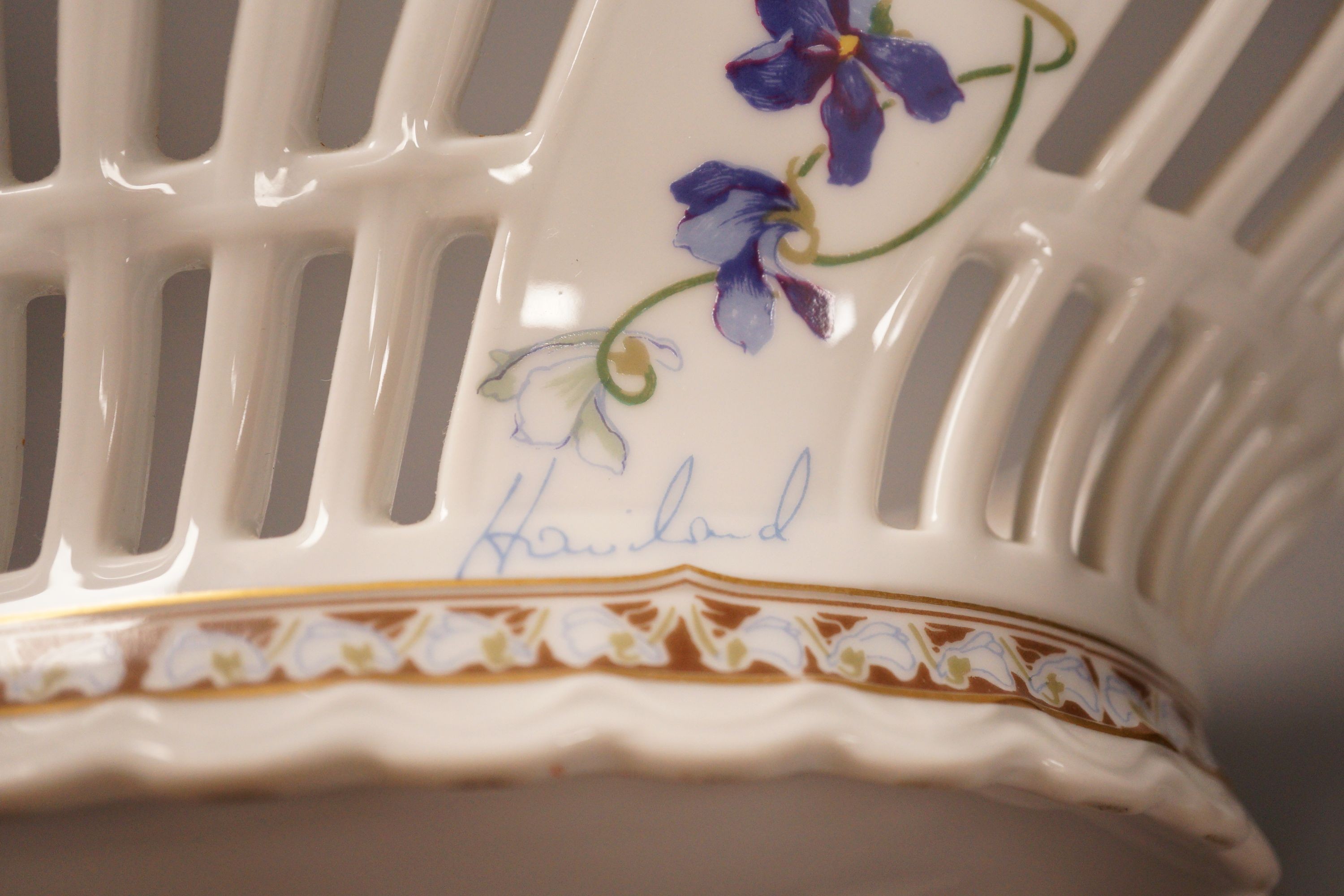 A Haviland Limoges fruit basket, painted with trailing flowers, 41cm